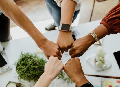 Business people bumping fits in the middle